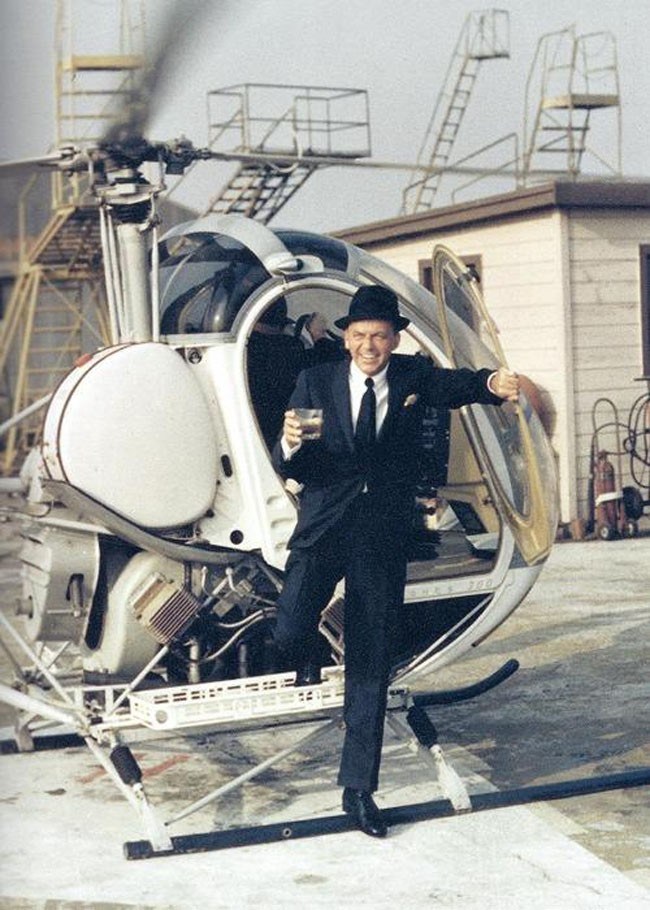 Frank Sinatra sortant d’un hélicoptère avec une boisson